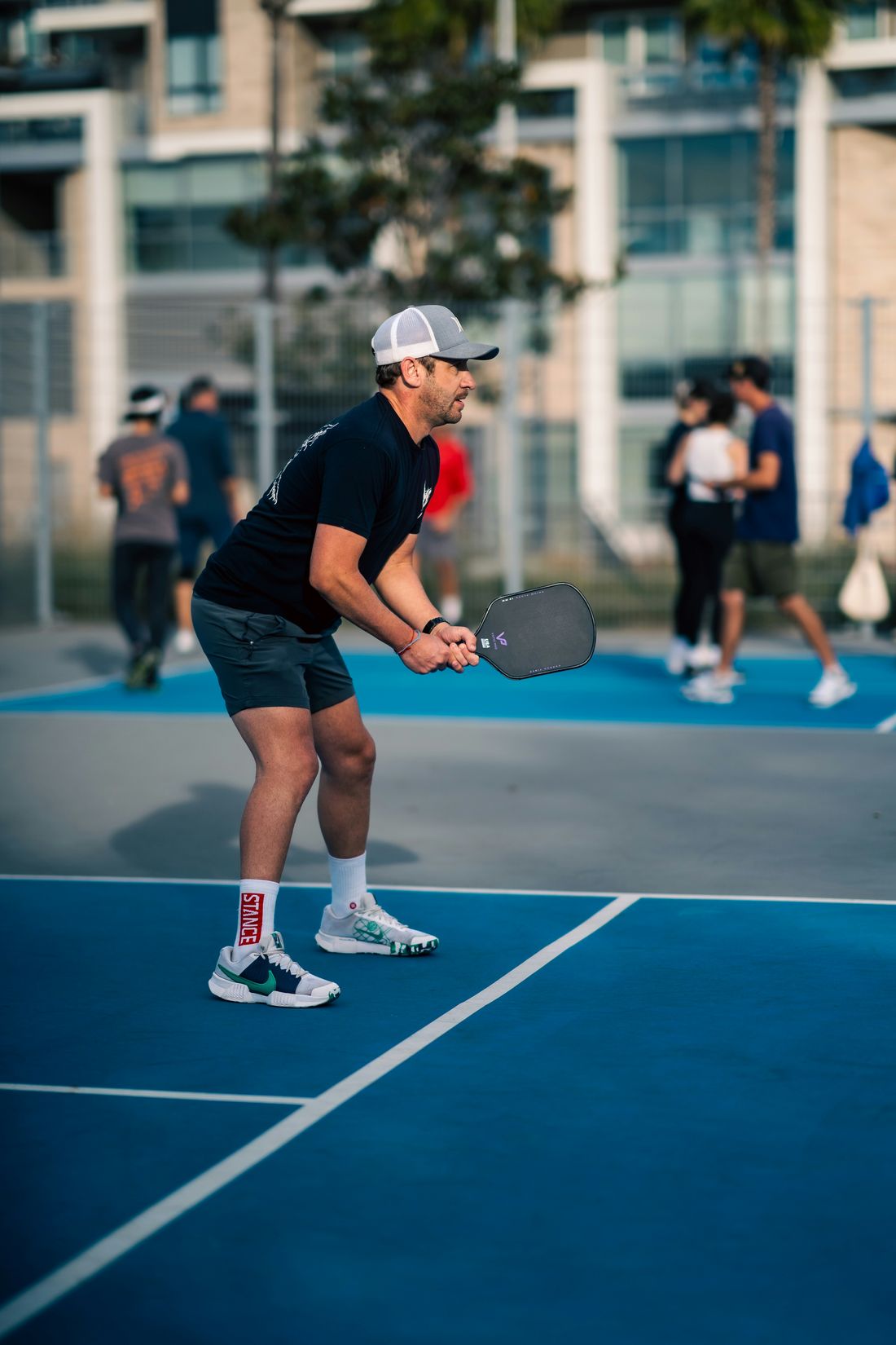 Pickleball player in a ready stance, the kind of movement acupuncture for low back pain helps people return to