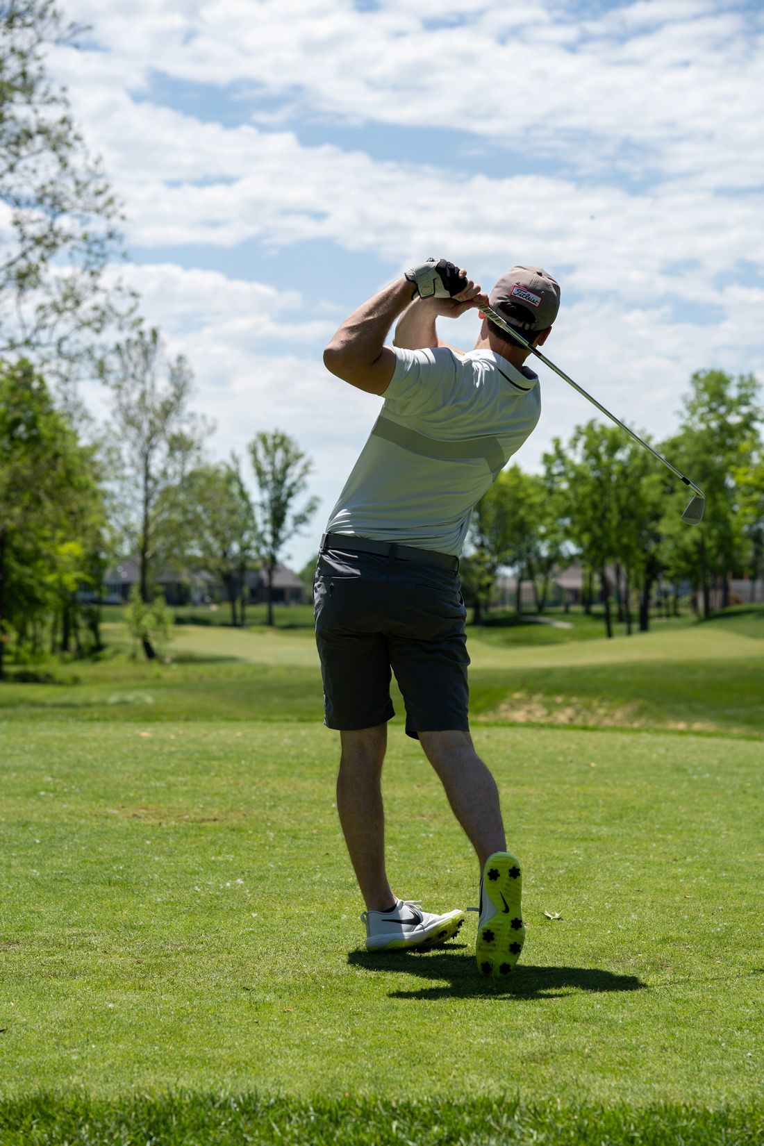 Golfer following through on a swing, knees rotating freely