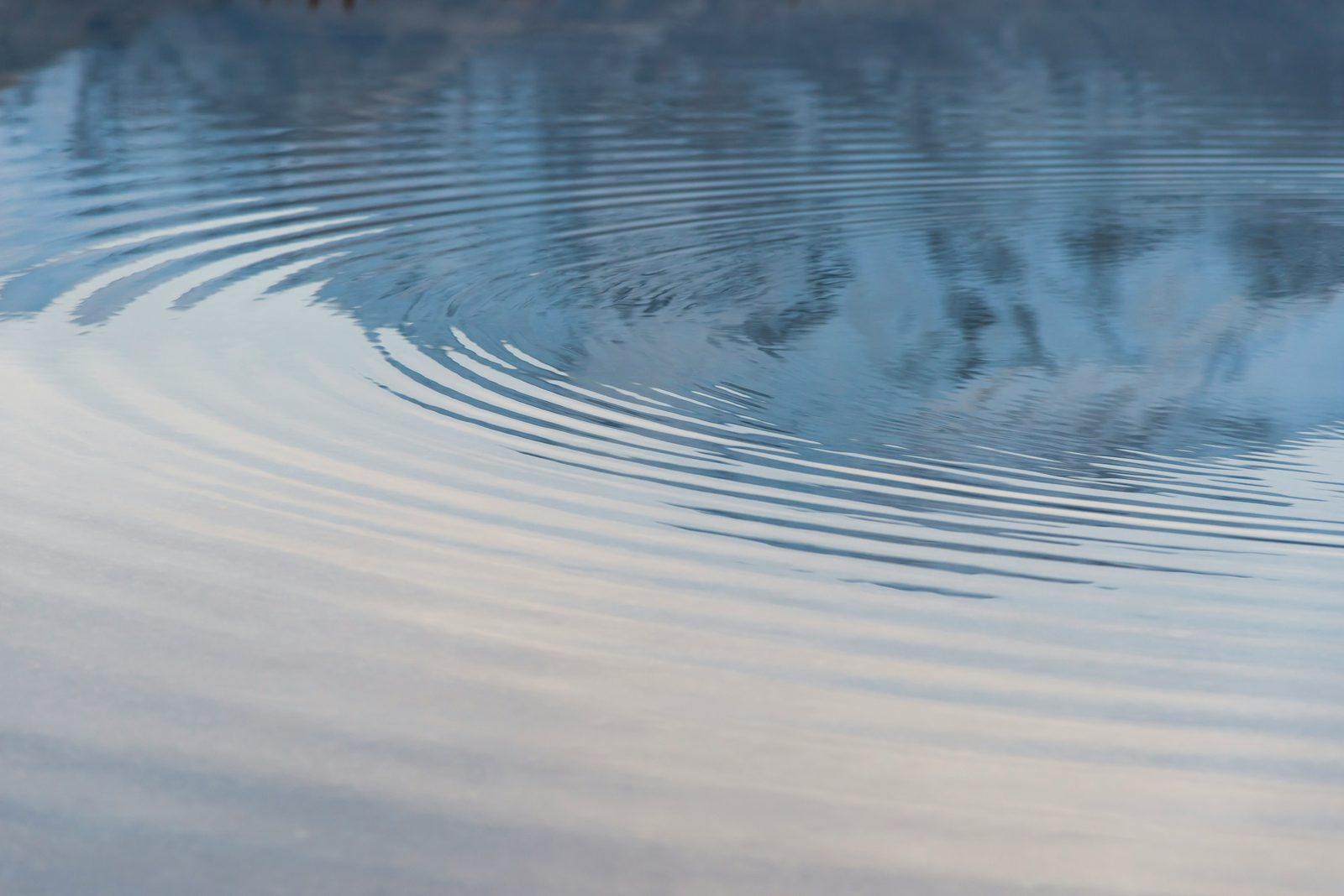Gentle ripples spreading across still water that mirrors the sky: acupuncture for stress and anxiety in Waimea and Kona, Hawaii